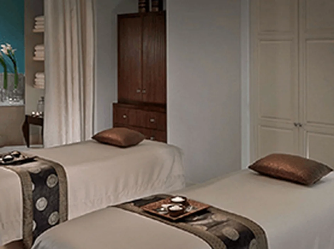 Quiet hotel room with soft seating and timber details